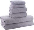 A stack of gray towels sitting on top of each other on a white background.