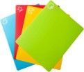 Four colorful cutting boards are stacked on top of each other on a white background.