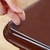 A close up of a person 's hand touching a laptop on a table.