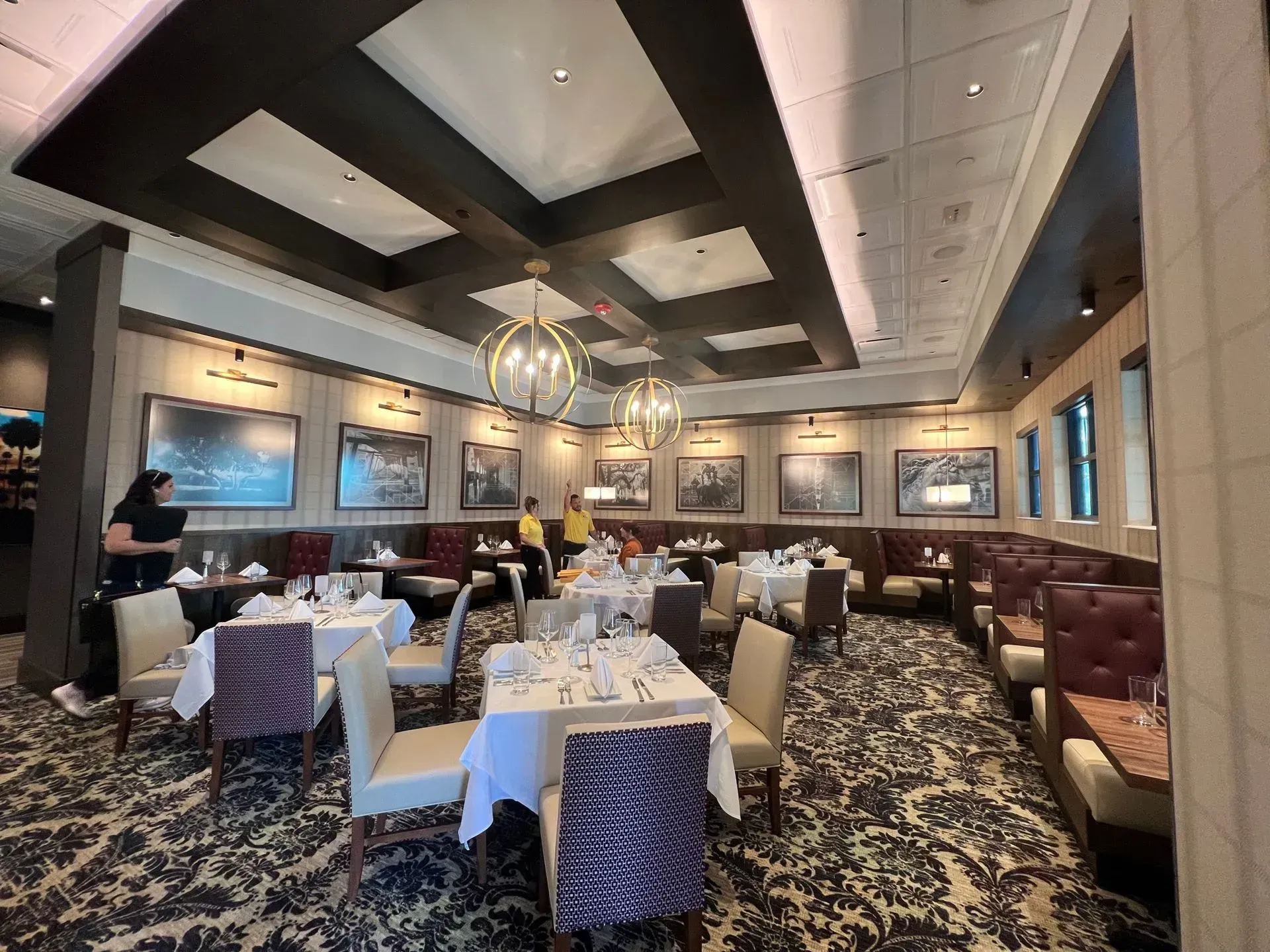 A large dining room with tables and chairs in a restaurant.