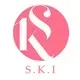 Pink circle with white stylized letters