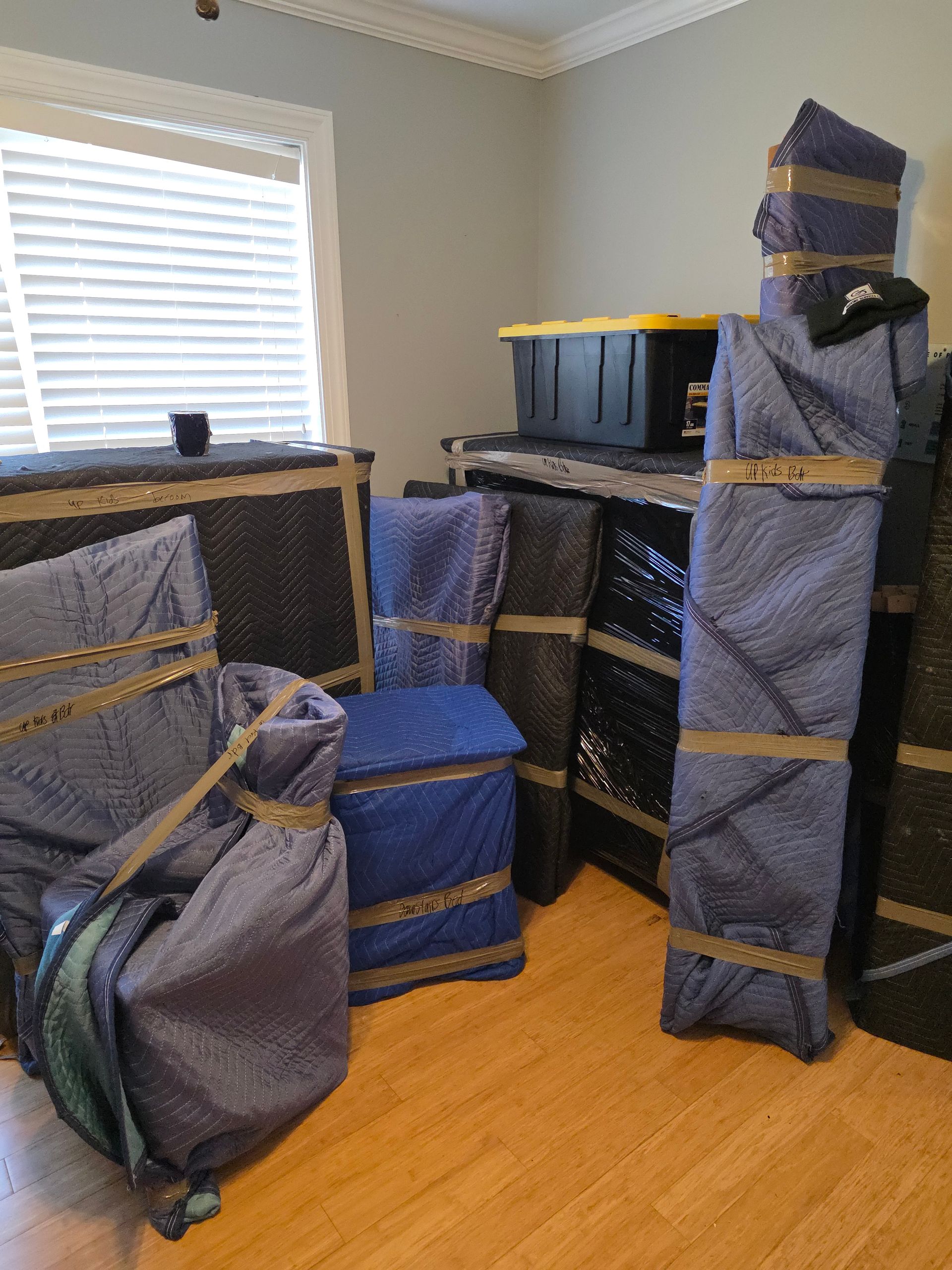 CJ Moving Services mover carefully wrapping furniture for a senior's move in Durham