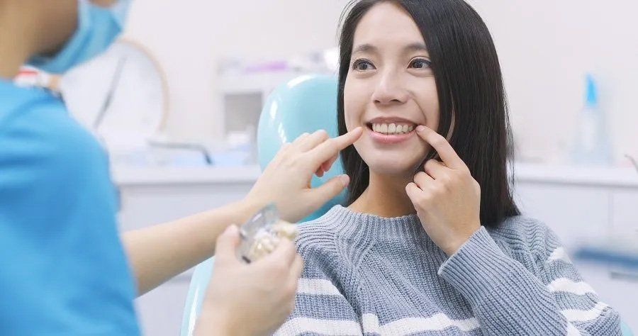 Woman with Dentist in Dental Clinic — Amherst, OH — Gregory Sy, DDS