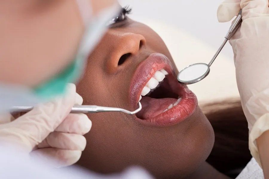 Female Patient Being Examined by Dentist in Clinic — Amherst, OH — Gregory Sy, DDS