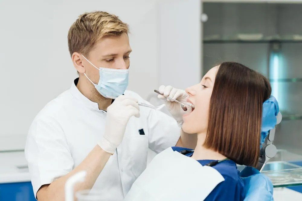 Dentist Examines a Female Patient — Amherst, OH — Gregory Sy, DDS