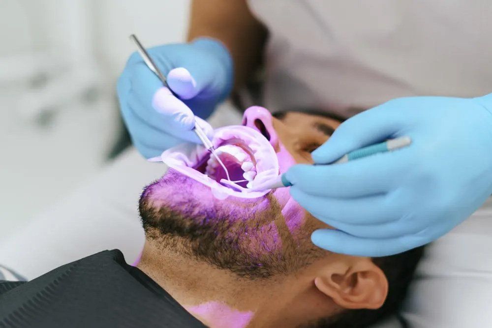 Man with Patient Bib on a Dental Chair — Amherst, OH — Gregory Sy, DDS