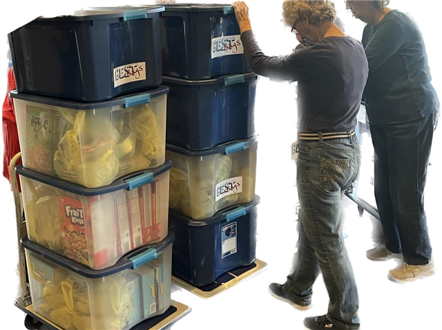 A group of people are stacking plastic bins on top of each other for best bags for allen elementary school.