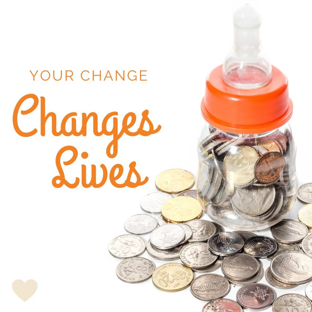 A baby bottle filled with coins and the words 