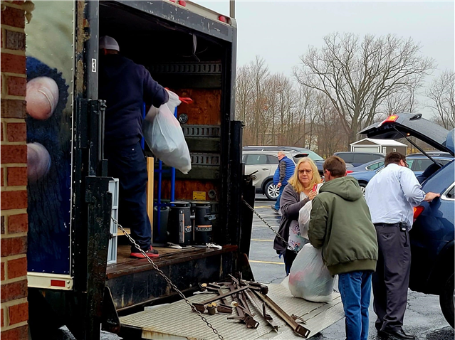 Church members are loading a Grant County Rescue Mission truck in the church parking lot