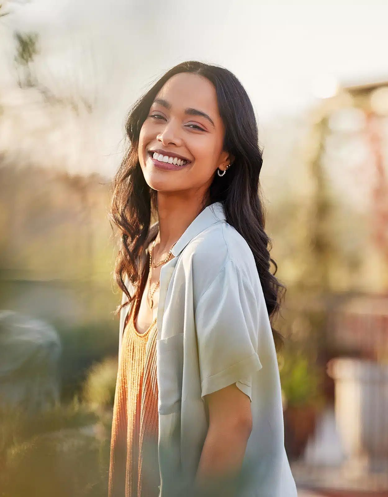 woman with long brunette hair smiling