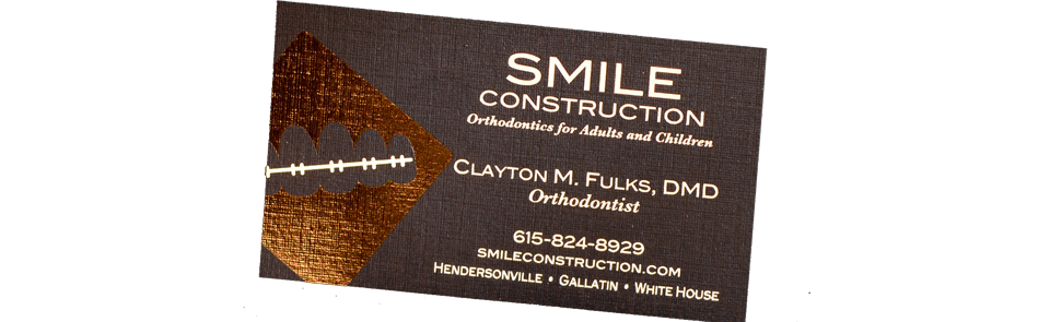 A close up of a business card for smile construction