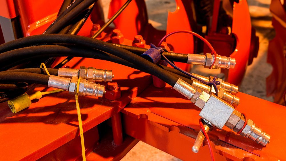 Hydraulic Hoses With Silver Couplings  — Northern Heavy Machinery in Mount Louisa, QLD