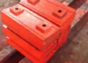Stack of Bright Orange Metal Blocks With Square Holes — Northern Heavy Machinery in Mount Louisa, QLD