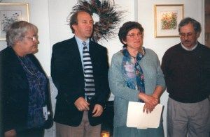 Four people standing, indoors