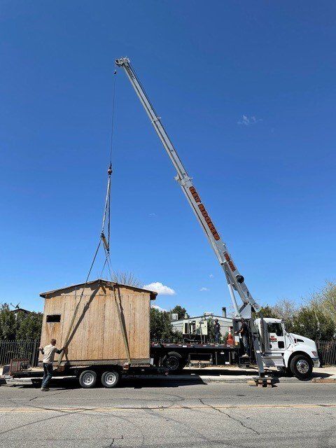 Green Container Lifted by a Crane — Lancaster, CA — Get Hooked Crane Service