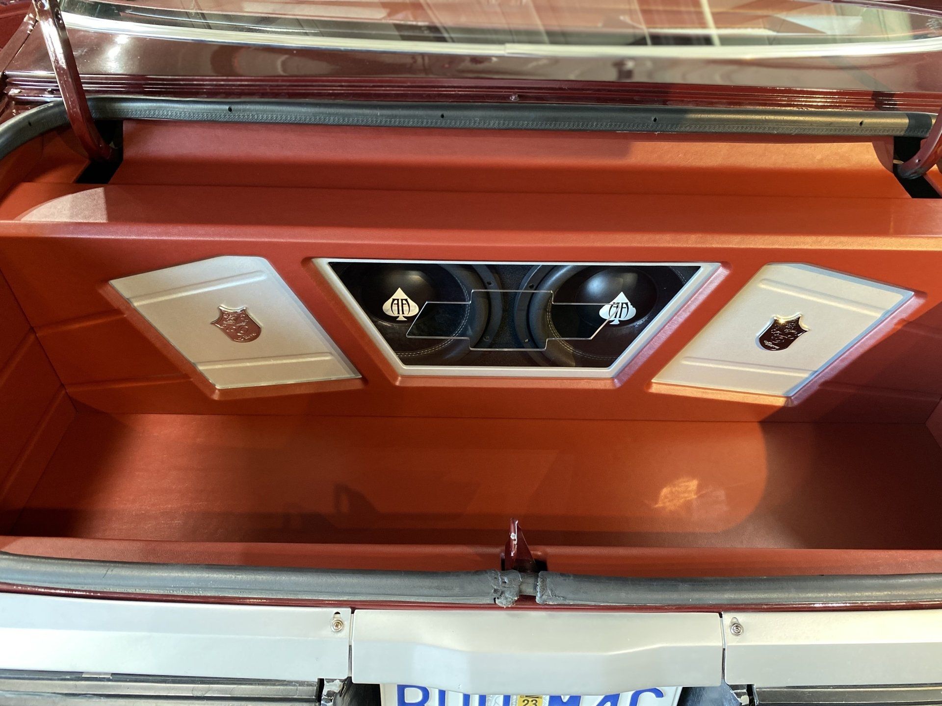 Orange car interior ceiling with three chrome-trimmed light panels and a central vent