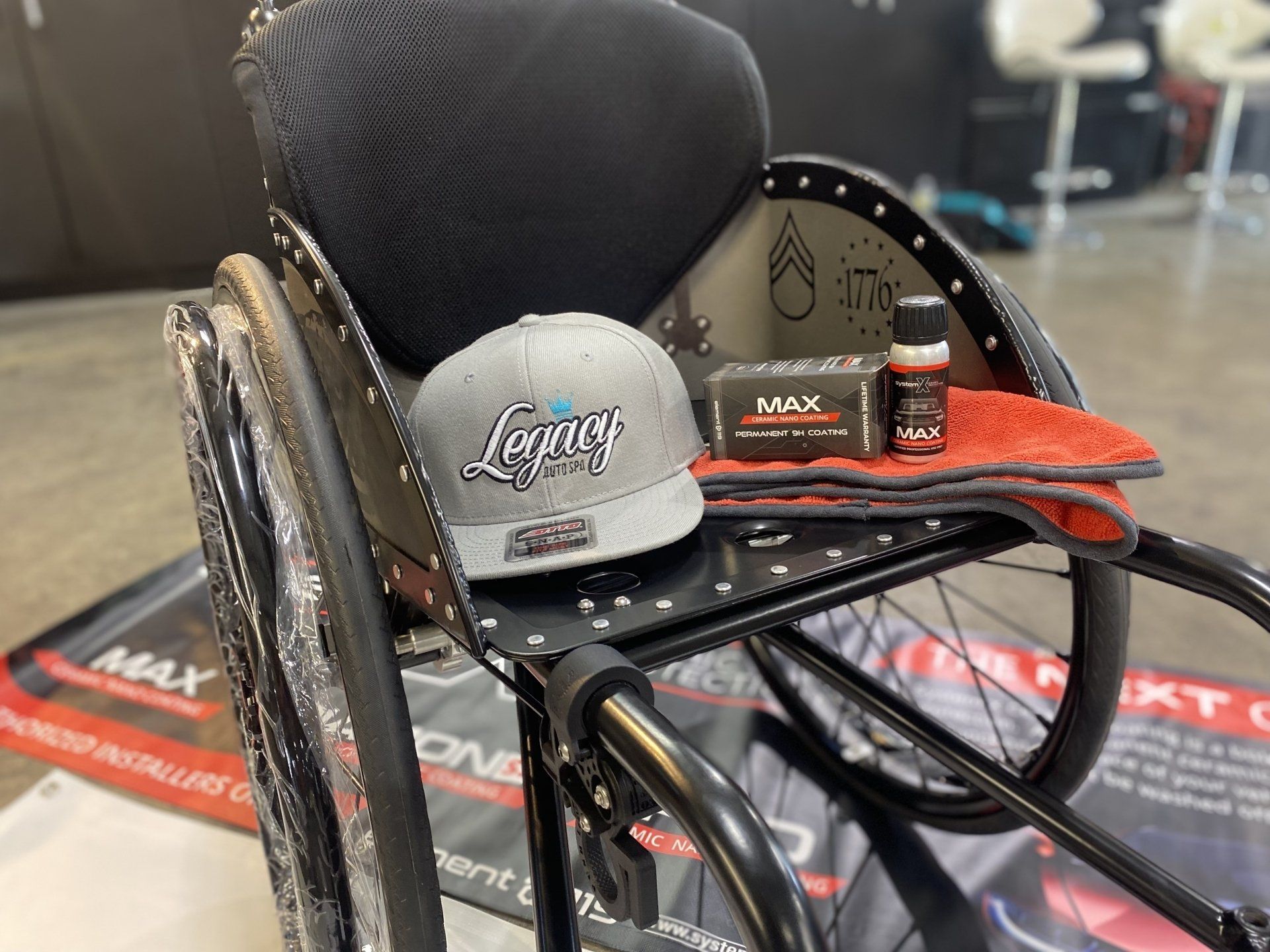 Motorized wheelchair with a gray cap and orange accessory on the seat
