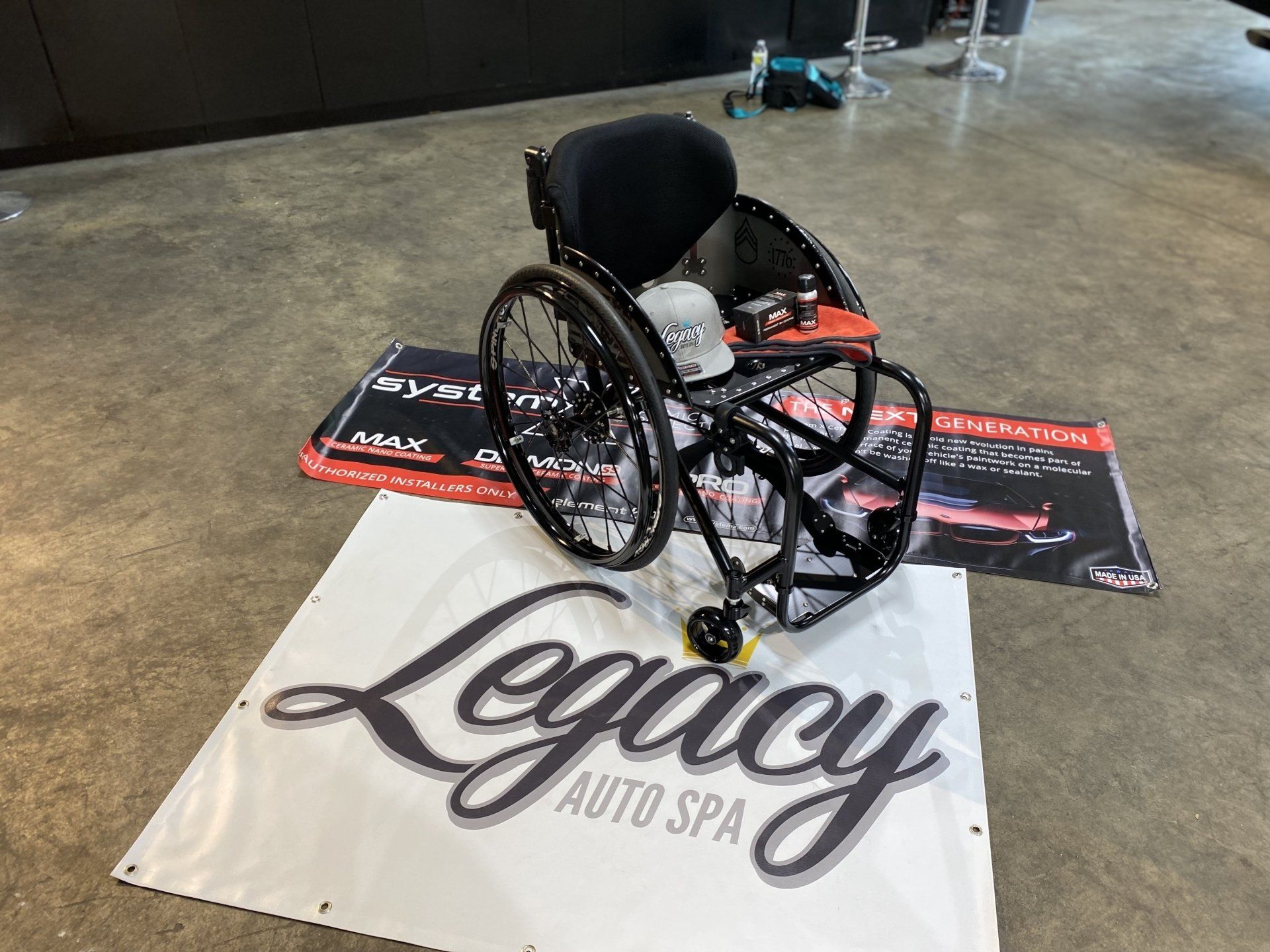 Wheelchair displayed on a Legacy Auto Spa logo mat in an indoor showroom.