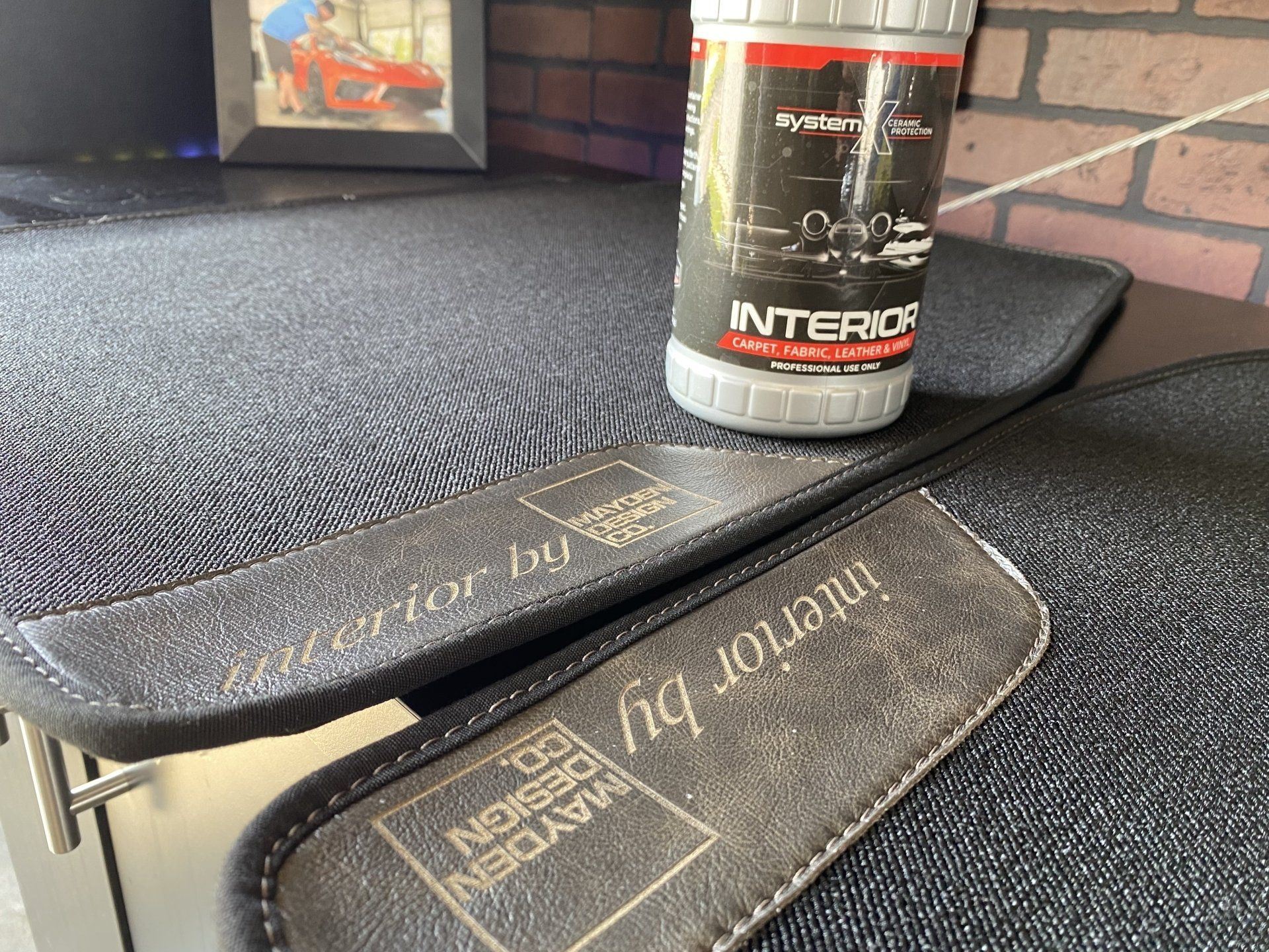 Two bicycle grips on a carpeted surface with a black and red can sitting on top