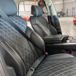Black diamond-stitched car seats with center console in a modern vehicle interior