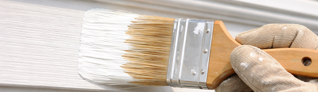 Exterior Trim Painting A painter using a paintbrush to paint exterior trim