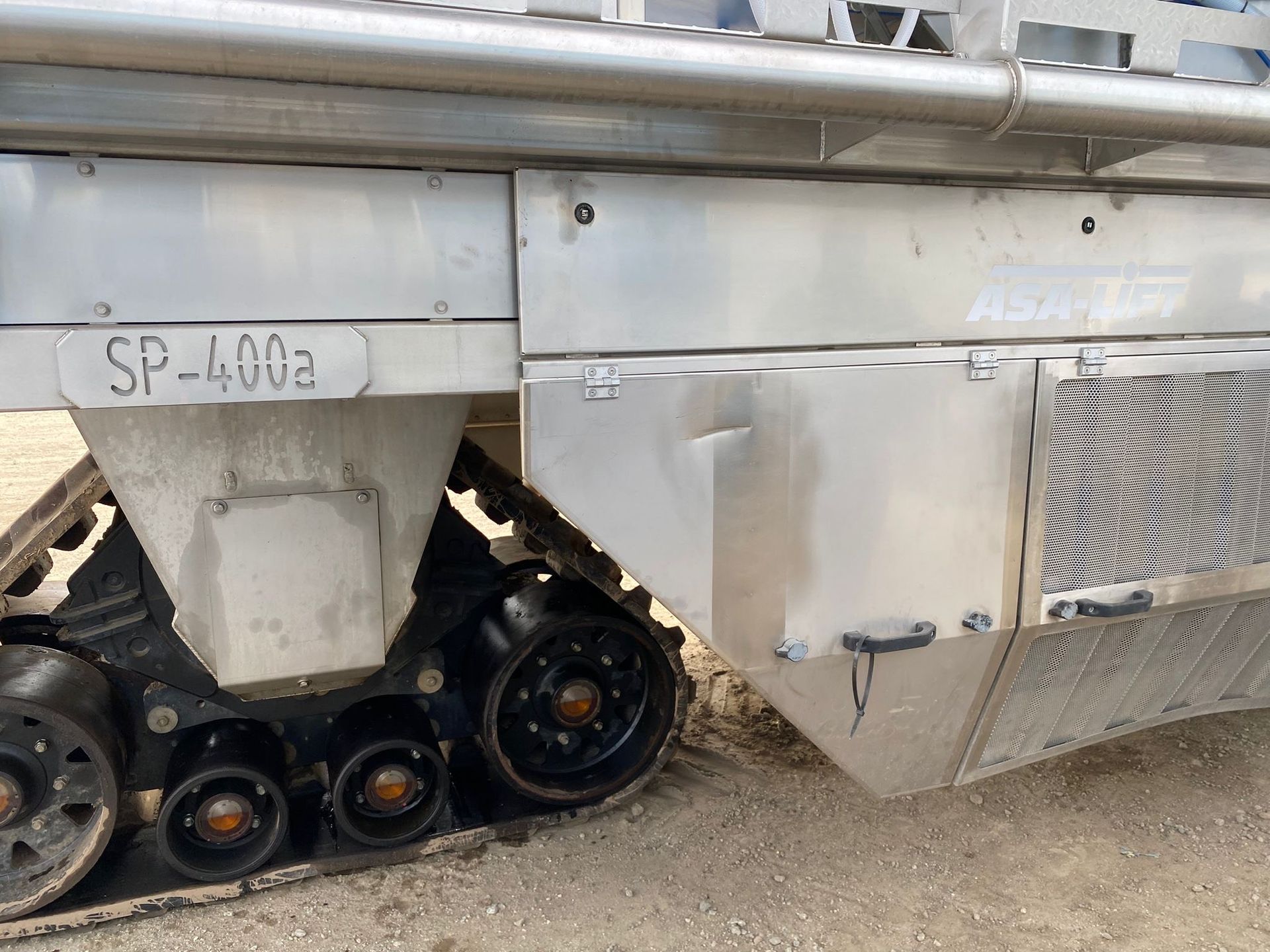 Side view of a tracked vehicle's metal body, displaying