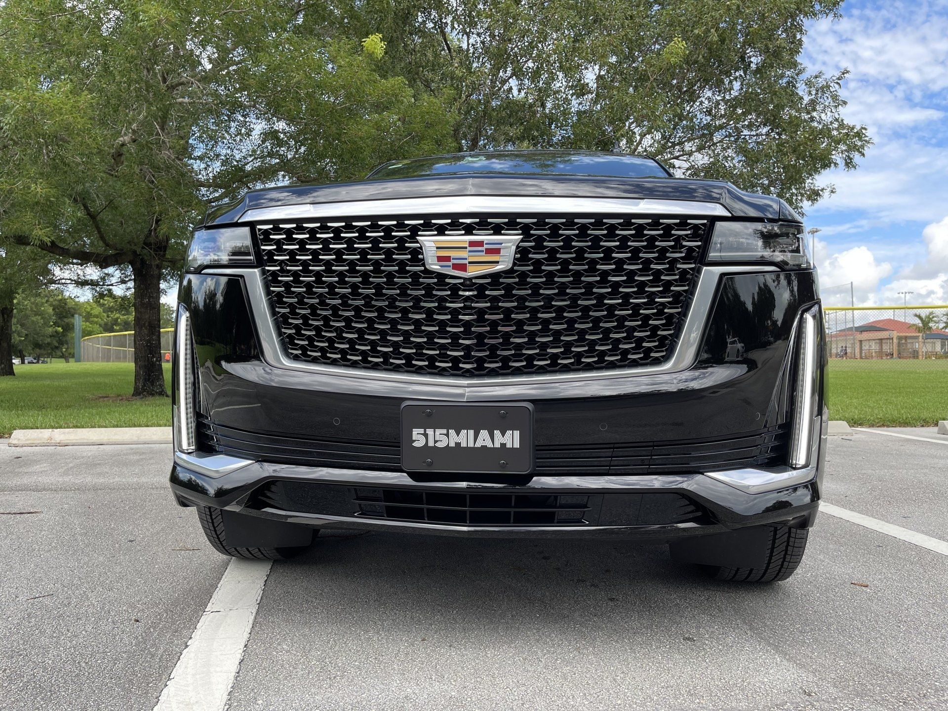 Front grille of a black 515 MIAMI Cadillac Escalade ESV, the luxury SUV for Miami car service