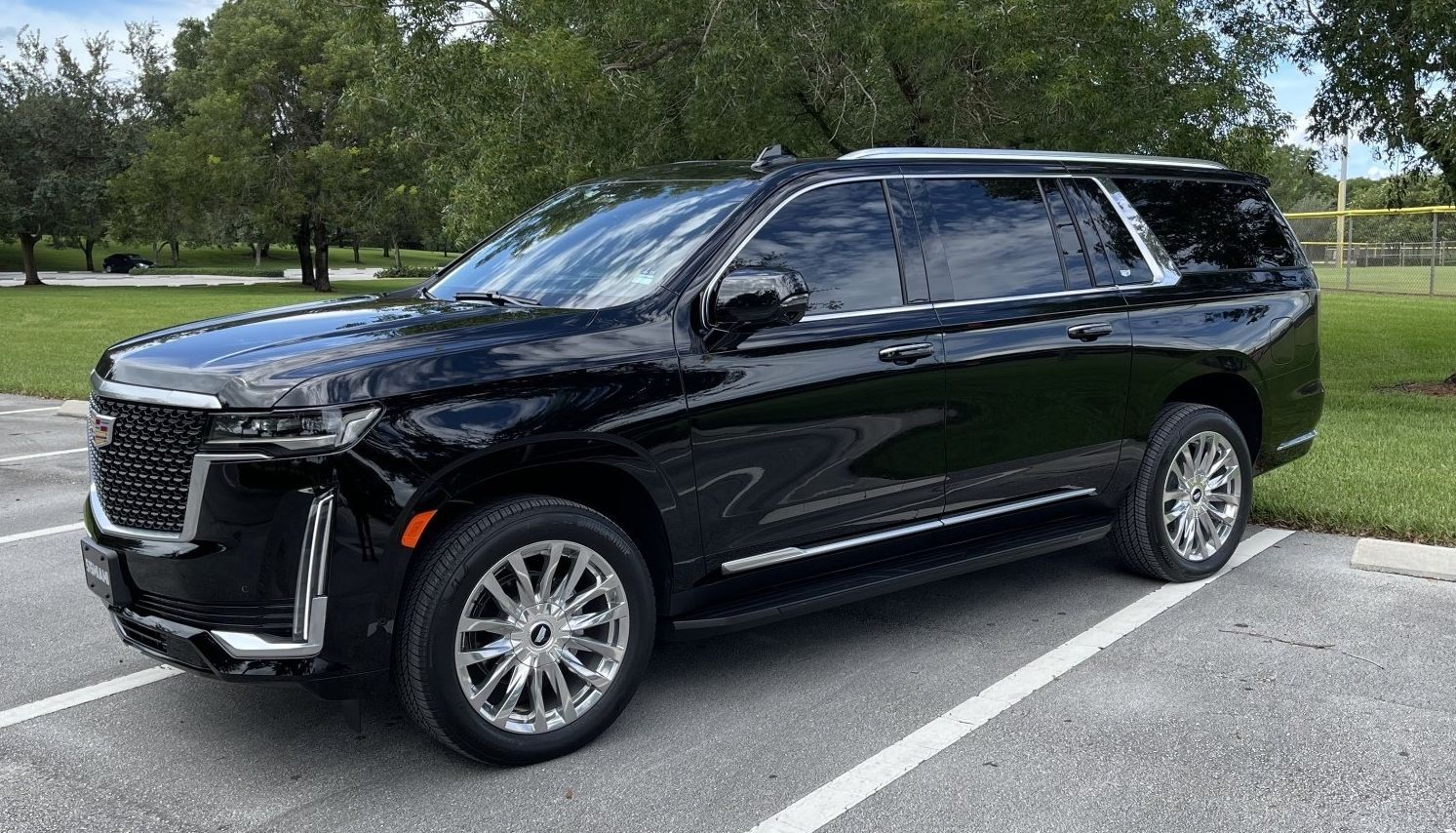 Side profile of a black 515 MIAMI Cadillac Escalade ESV, the long-wheelbase luxury SUV for 6 passengers and luggage