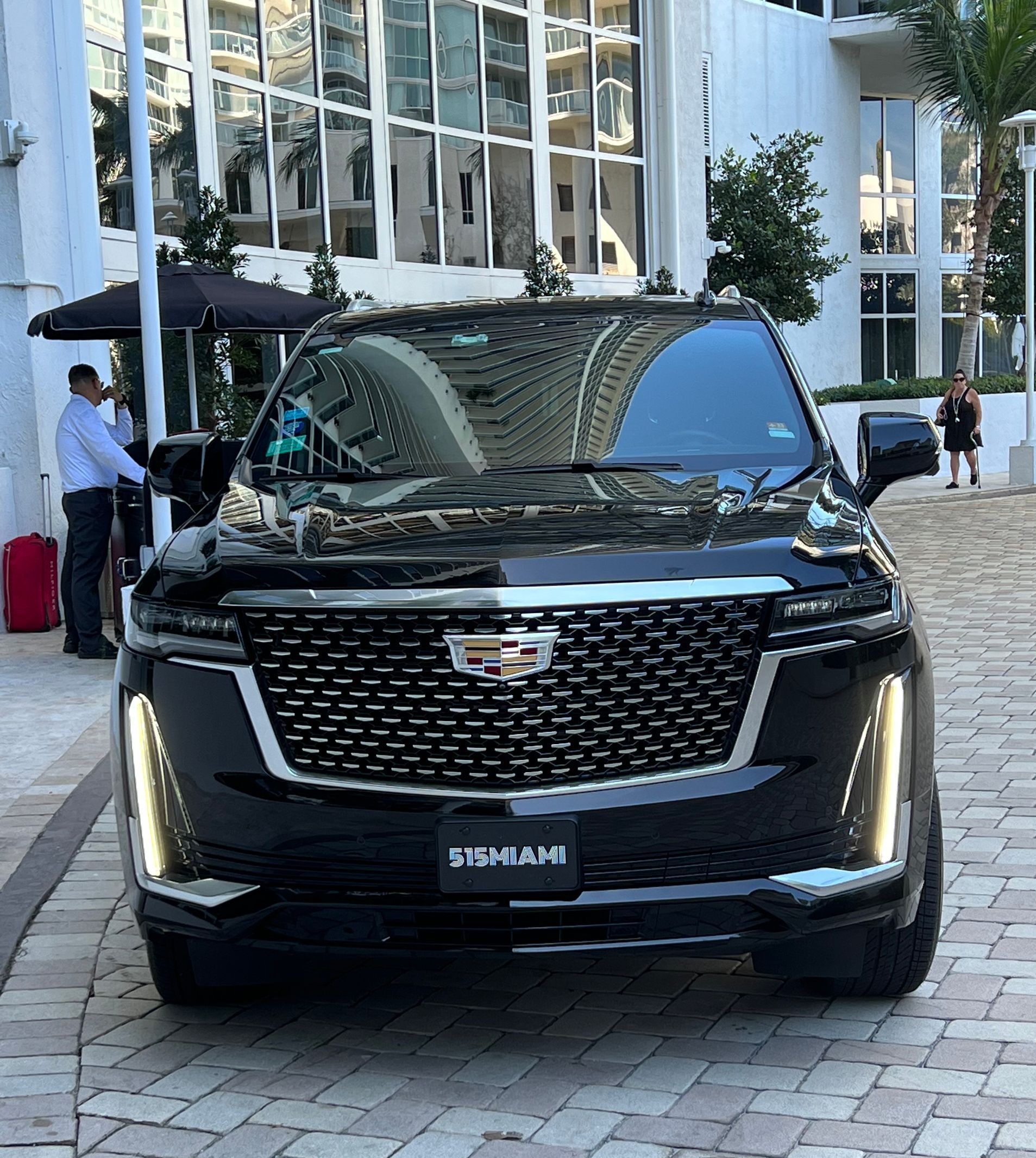 Chauffeured black Cadillac Escalade at a Miami hotel entrance for a night out pickup