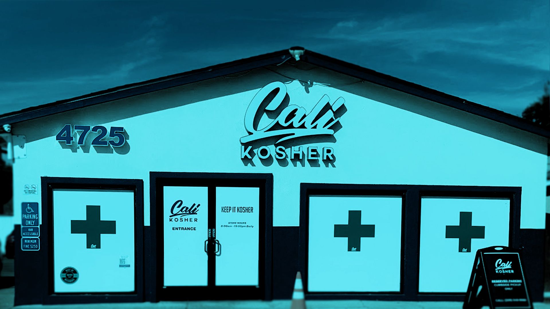 Front entrance of Cali Kosher’s Patterson dispensary, featuring a blue facade and accessible parking spaces.
