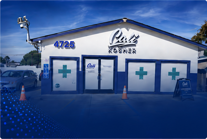 Front entrance of Cali Kosher’s Patterson dispensary, featuring a blue facade and accessible parking spaces.