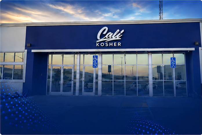 Front entrance of Cali Kosher’s Patterson dispensary, featuring a black-and-white facade and accessible parking spaces.