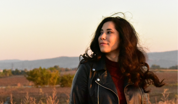 Woman in field embracing her authenticity
