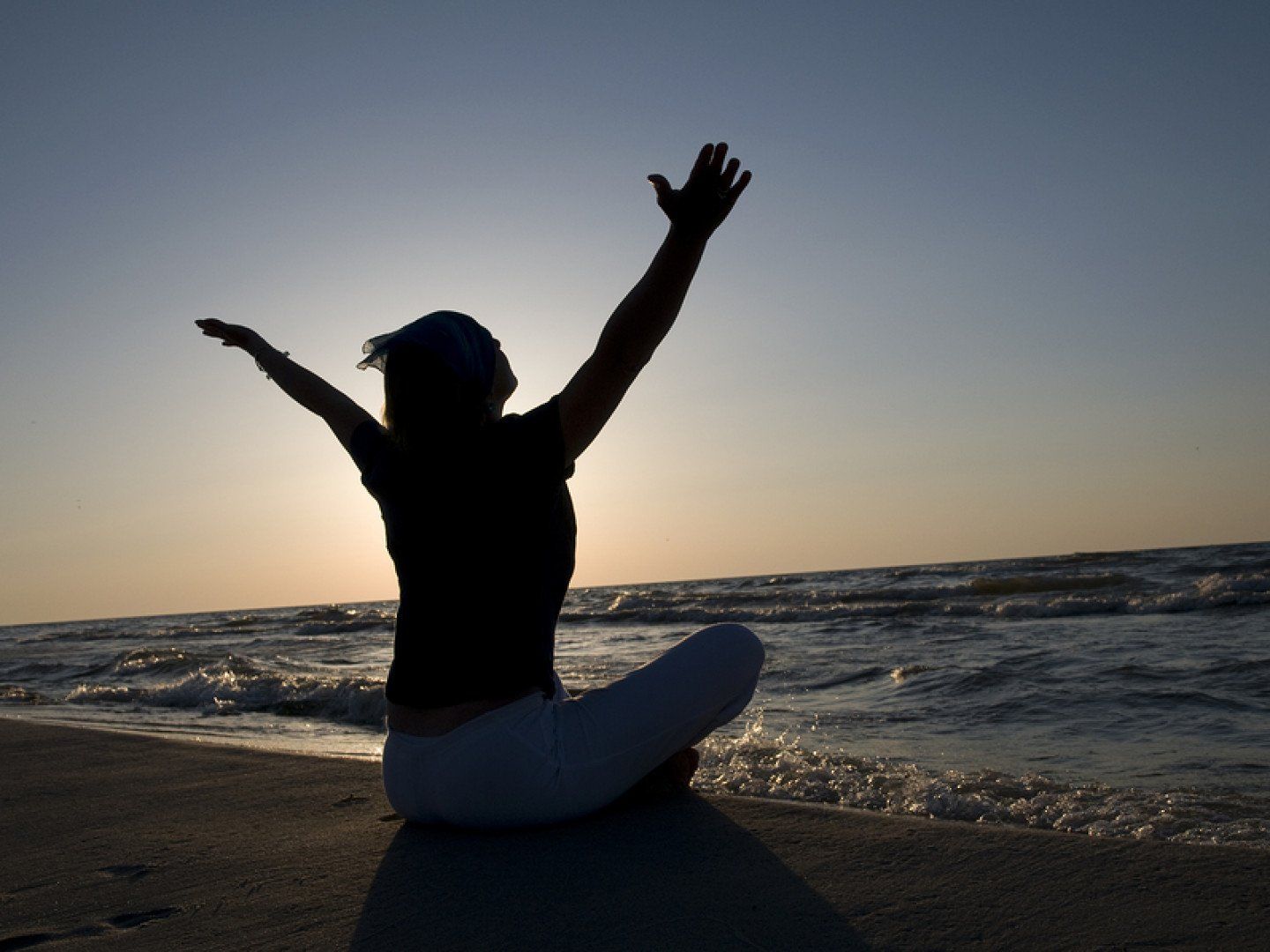 Woman Meditating on Beach