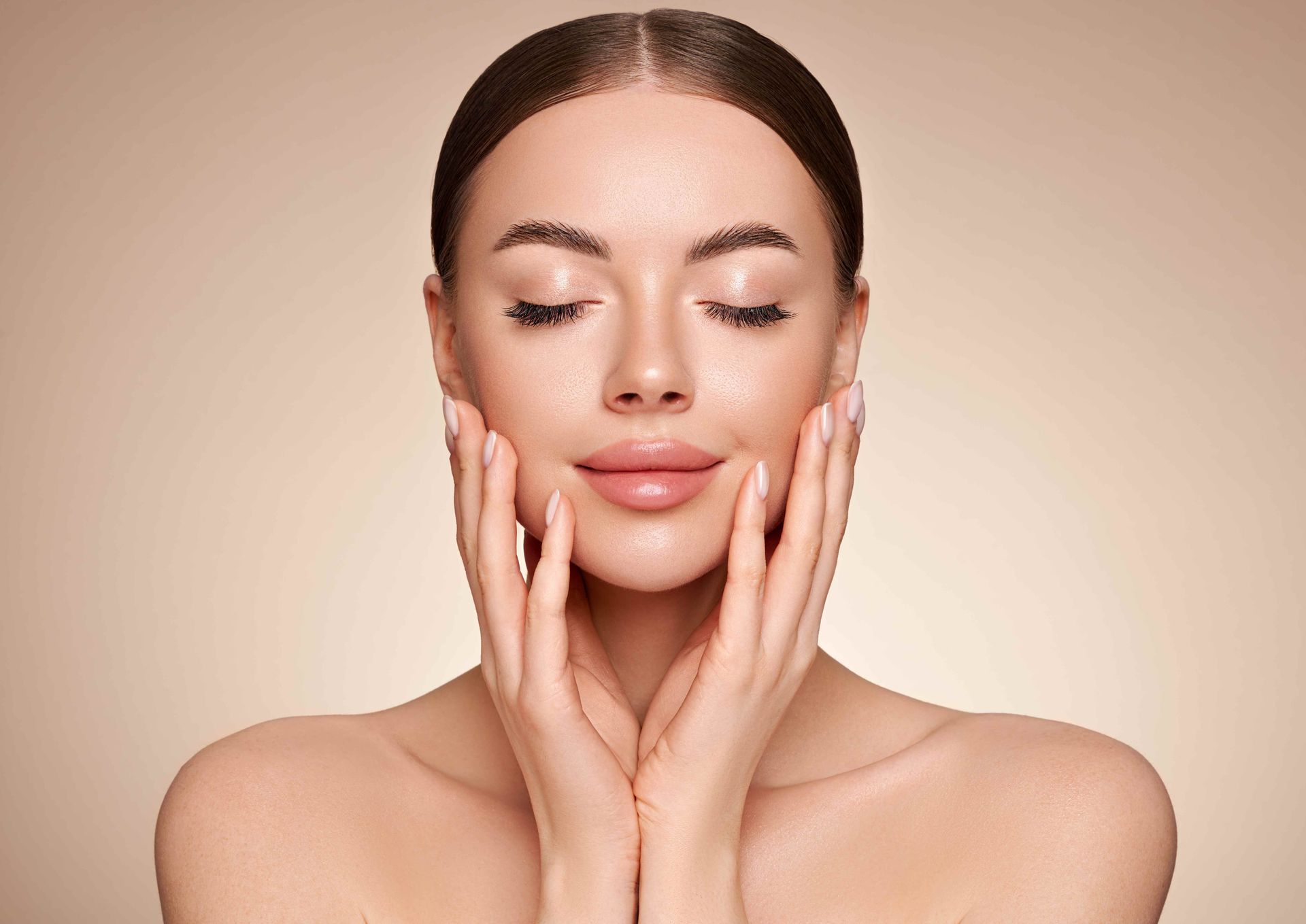 a woman with her eyes closed touches her face with her hands