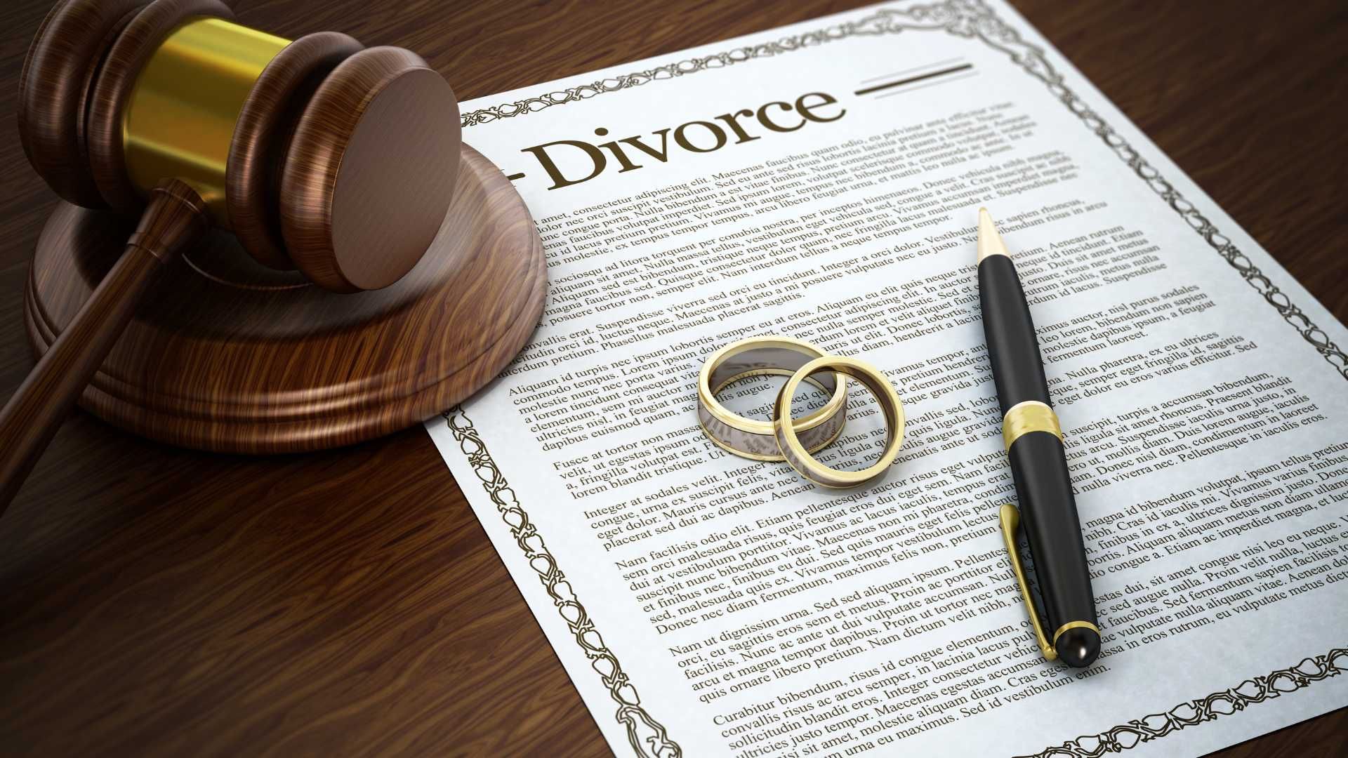a pair of wedding rings sit on top of a divorce document next to a judge 's gavel .