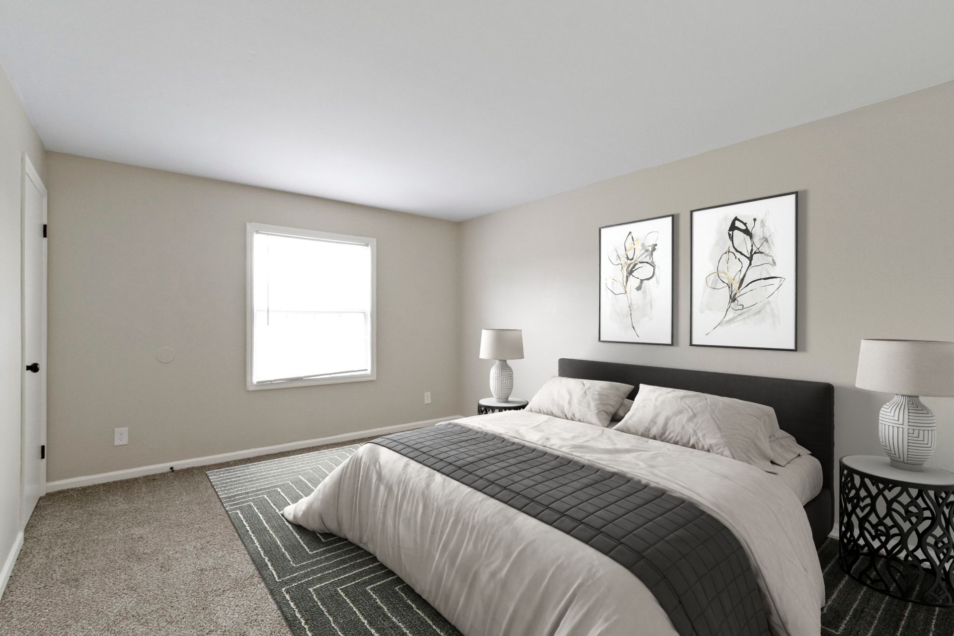Bedroom with a bed, two nightstands with lamps, two art pieces, and a window.