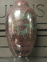 Red ceramic urn with birds and floral patterns.