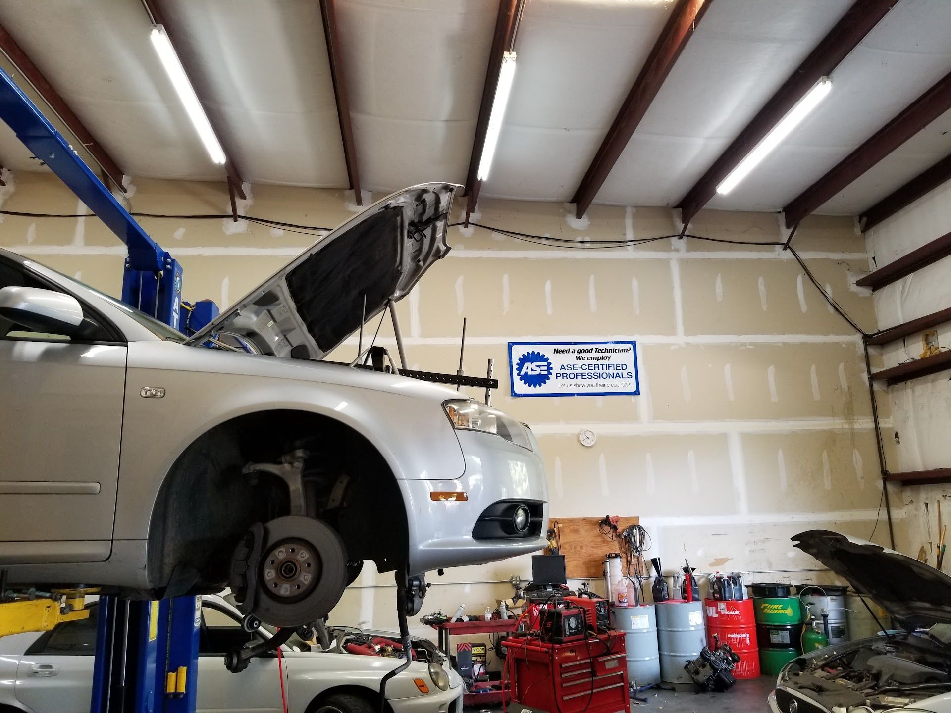 Silver Sedan on Lift for Brake Service in Kennesaw, GA | Revolution Auto Service