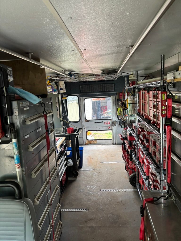 Inside an ambulance, showing shelves of medical supplies and equipment along the sides.