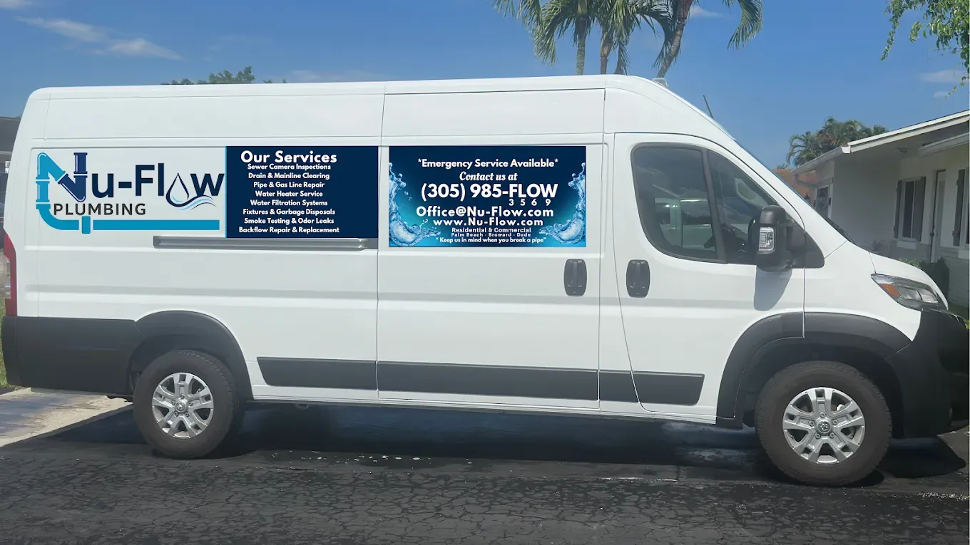 White Nu-Flow Plumbing service van with blue logo and contact info parked outdoors.