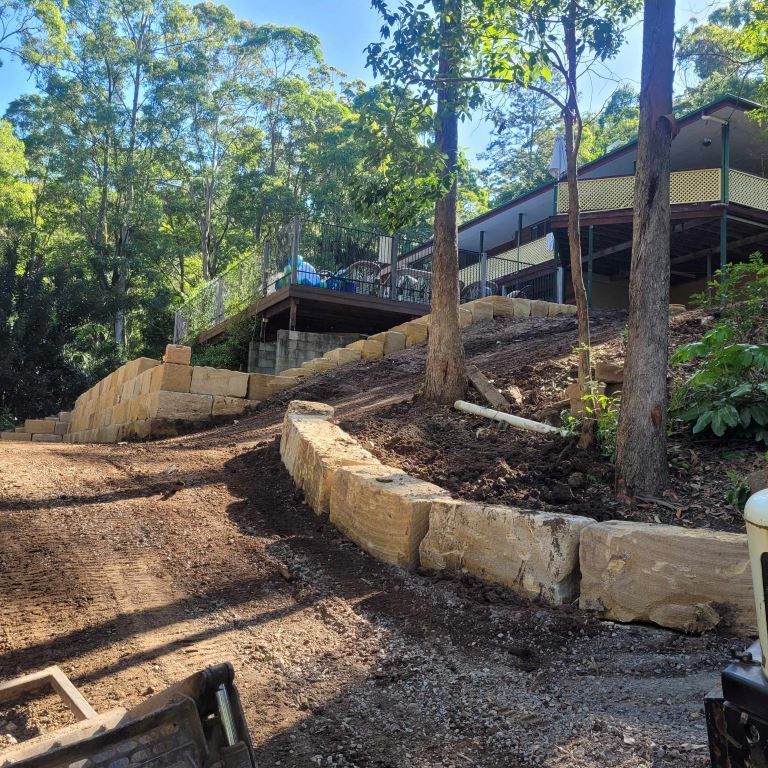 A House is Sitting on Top of a Hill Surrounded by Trees — Al's Excavation in Sunshine Coast, QLD