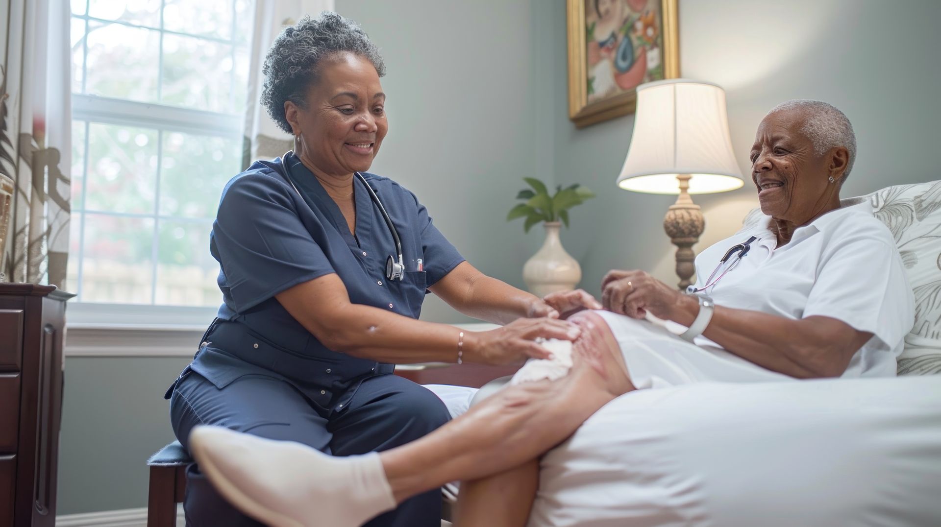 Nurse caring for elderly patient's knee Nurse caring for elderly patient's knee