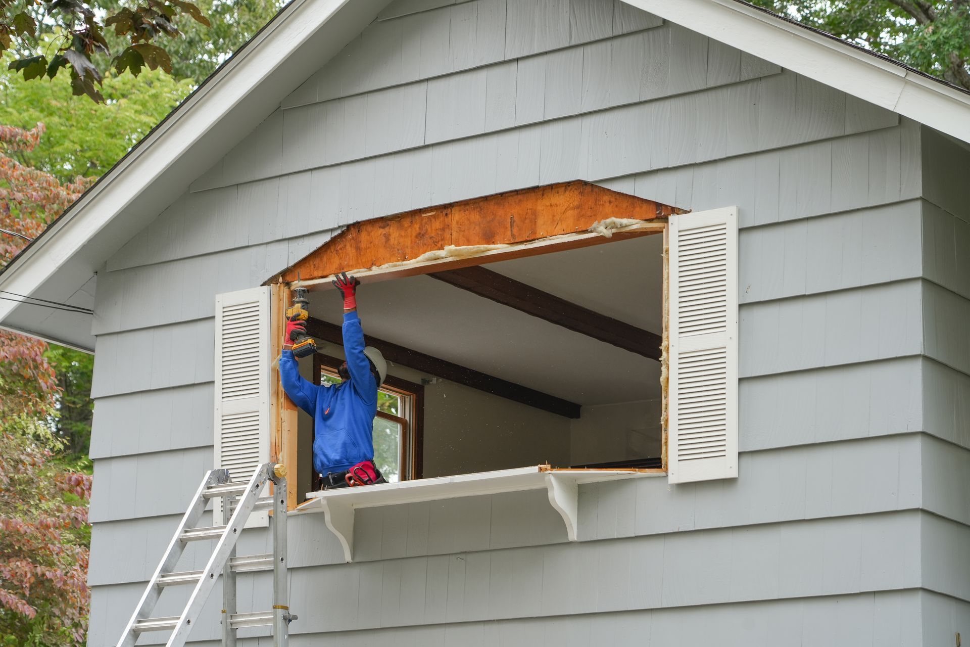 Person Installing Window With Drill On House Person Installing Window With Drill On House