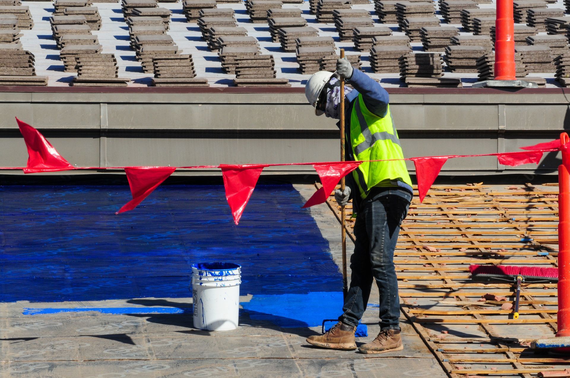 Construction Worker Painting Roof Surface Construction Worker Painting Roof Surface