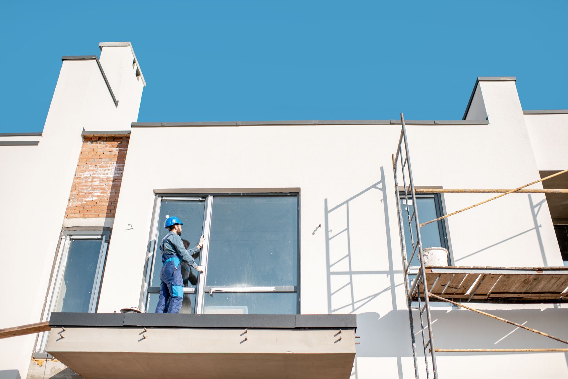 Construction Worker Installing Window On Building Construction Worker Installing Window On Building