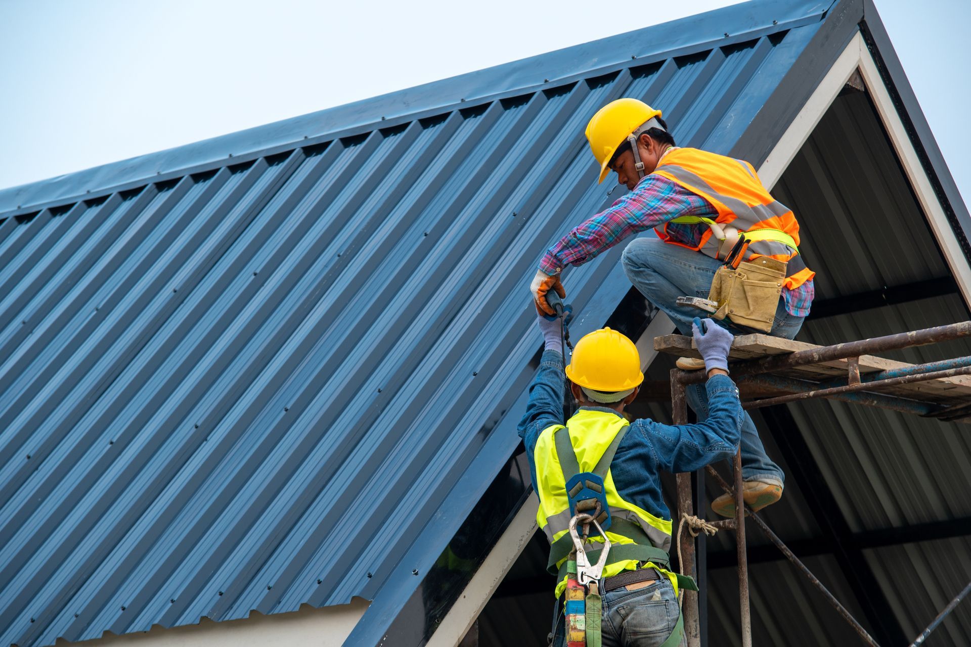 Two Roofers Installing Metal Roof Two Roofers Installing Metal Roof