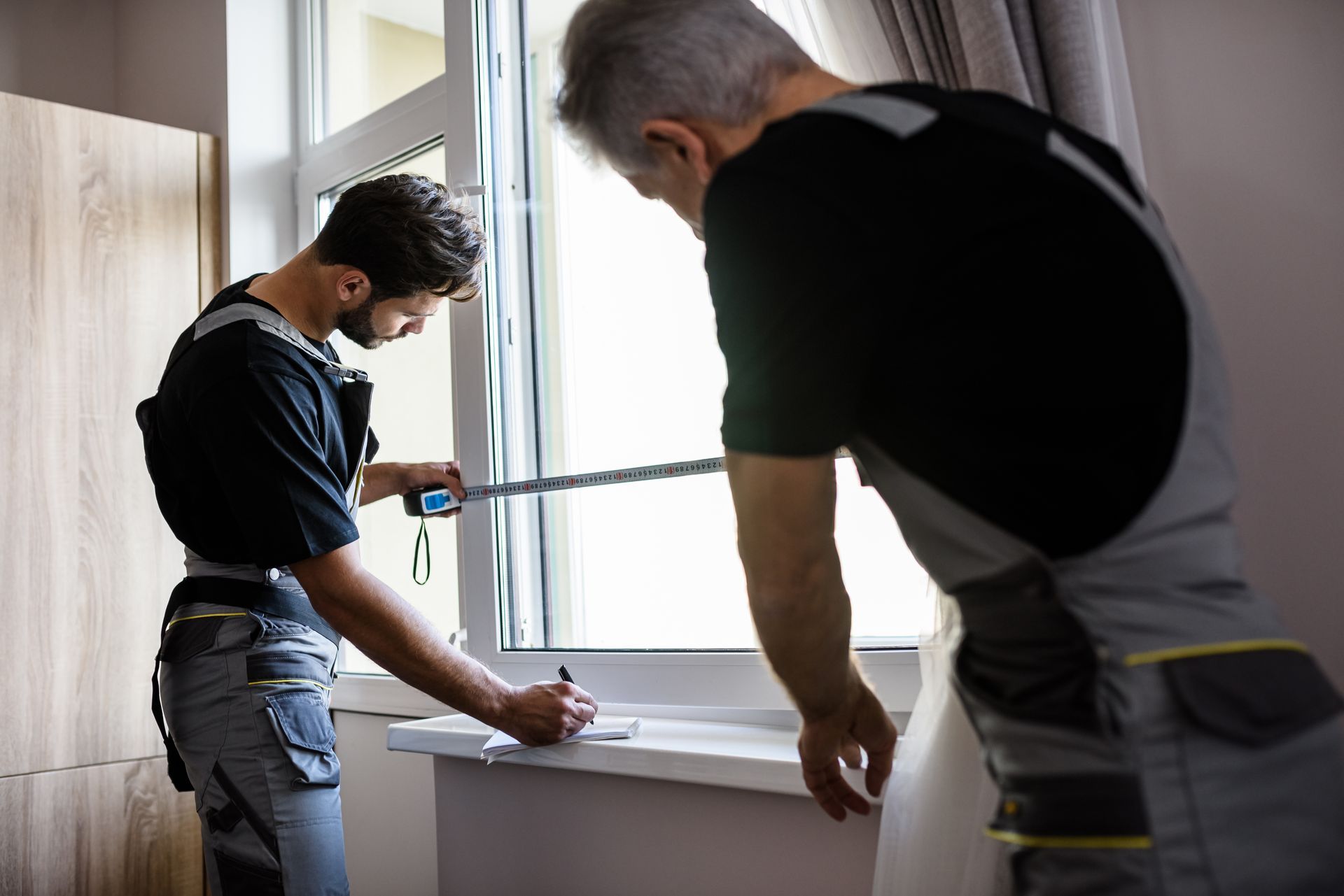 Two People Measuring Window For Installation Two People Measuring Window For Installation