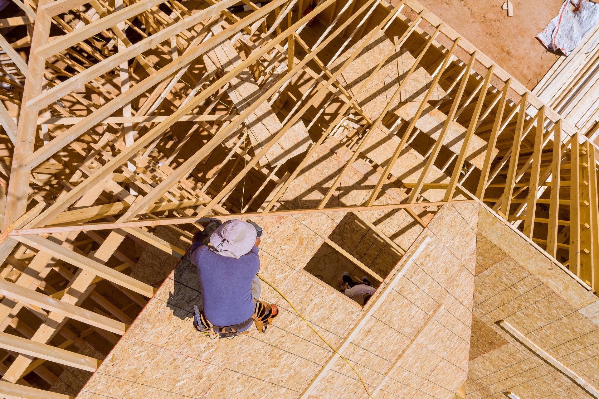 Roofer Installing Plywood On Roof Frame Roofer Installing Plywood On Roof Frame