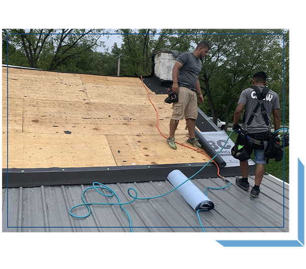 Two Workers Installing Roofing Materials Two Workers Installing Roofing Materials